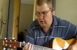Milo on acoustic guitar
